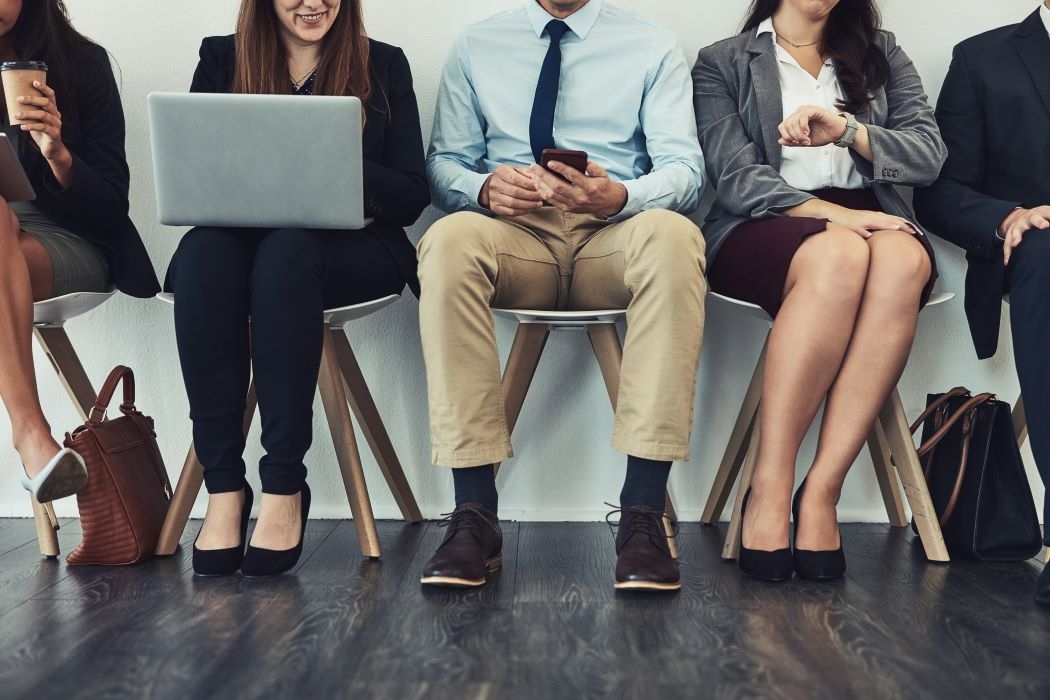 group of professional people sitting down waiting for interview