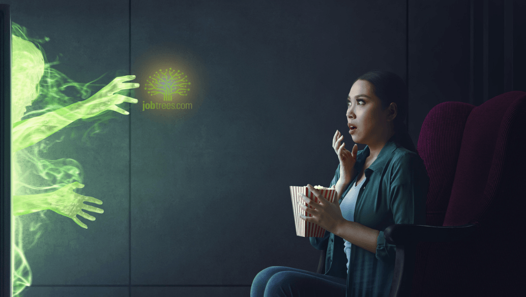 terrified woman eating popcorn watching a scary movie with ghosts coming out of the screen 