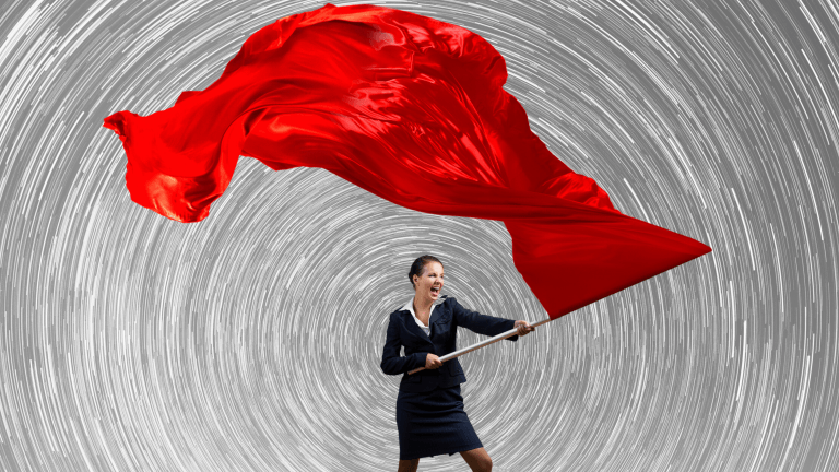 business woman waving a red flag at toxic workplace  